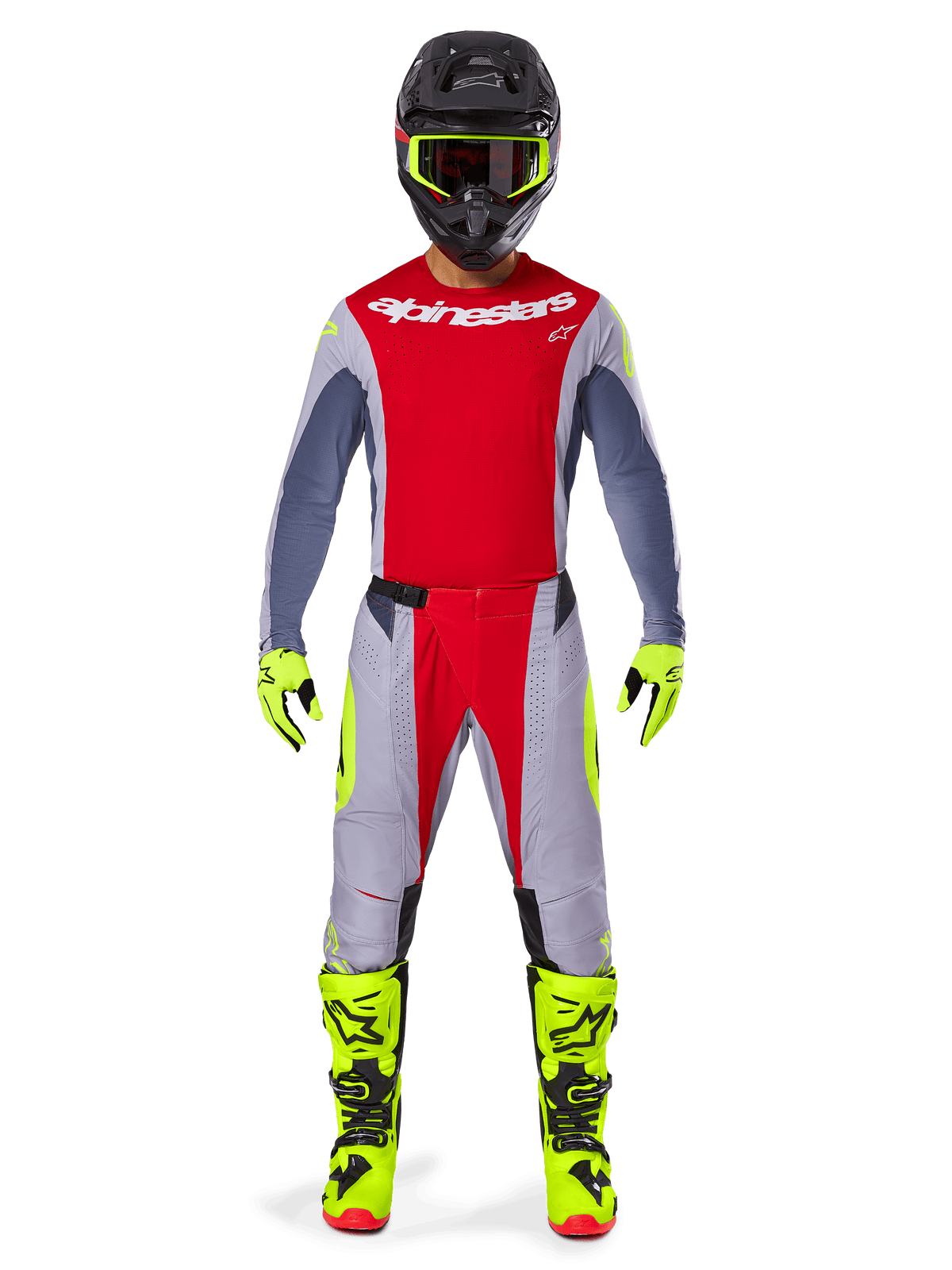Motocross rider wearing the Alpinestars 2025 Techstar Melt Gear Set, red jersey with gray sleeves and white logo, matching gray and red pants, fluo-yellow goggles, gloves, and boots, complete motocross racing outfit for off-road performance.