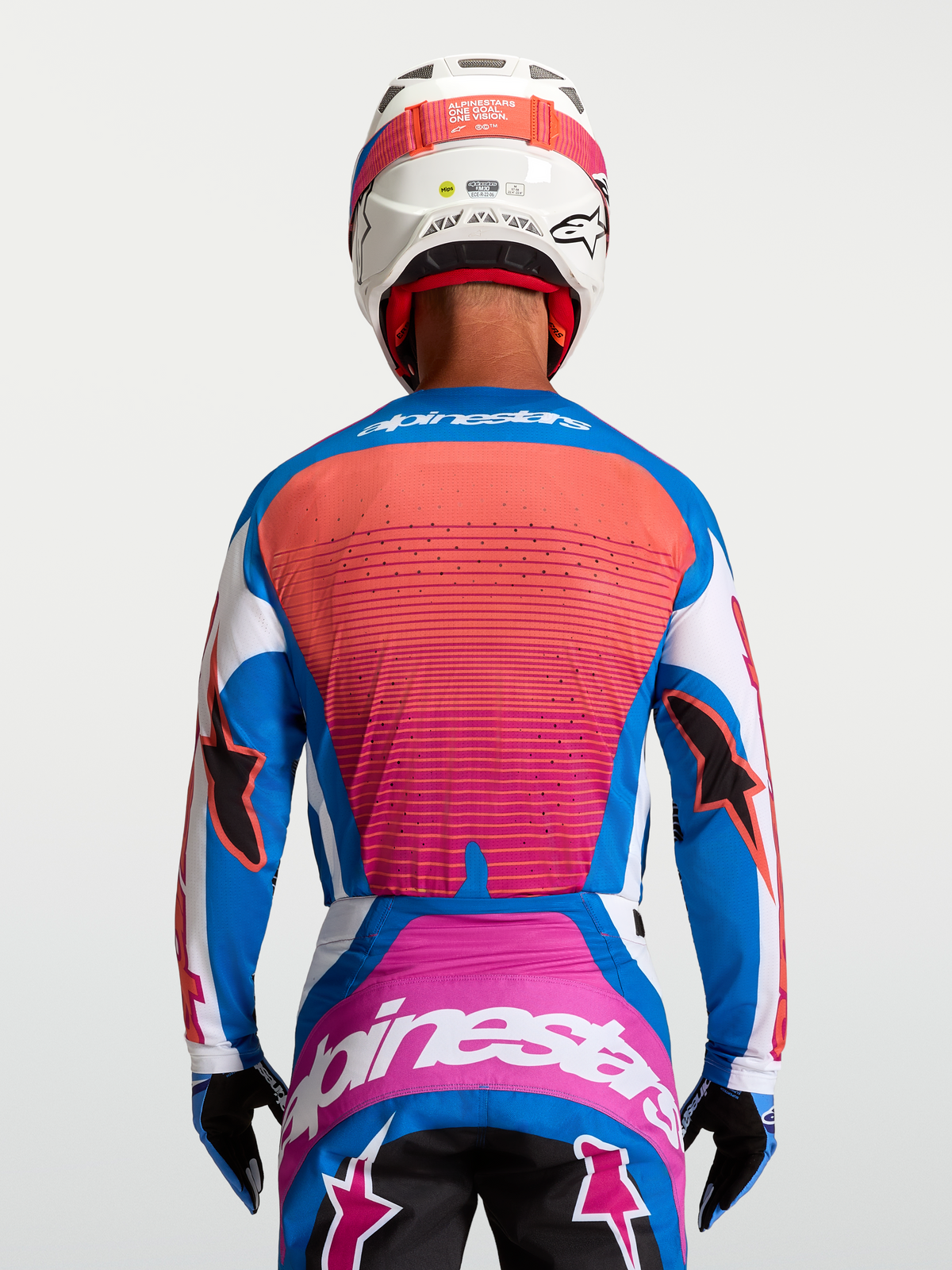 Koszulka Alpinestars Techstar Maven, męska koszulka motocrossowa, niebieska i koralowa, widok z tyłu na wentylowany panel.