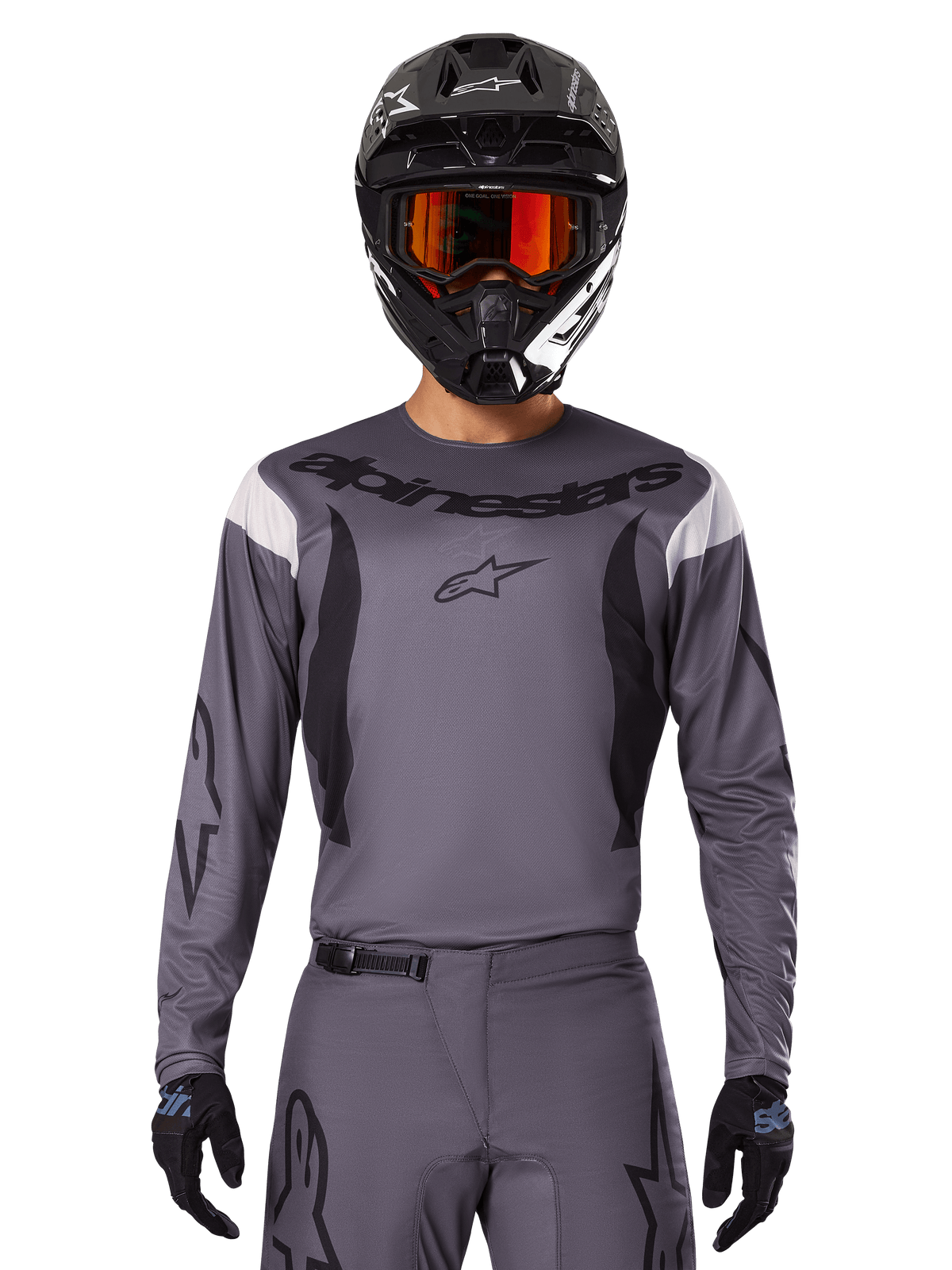Motocross rider wearing the 2025 Fluid Haul Jersey and Gear Set, Gray with black and white accents, featuring long sleeves and bold branding, black helmet with orange goggles, and black gloves, coordinated outfit for off-road racing