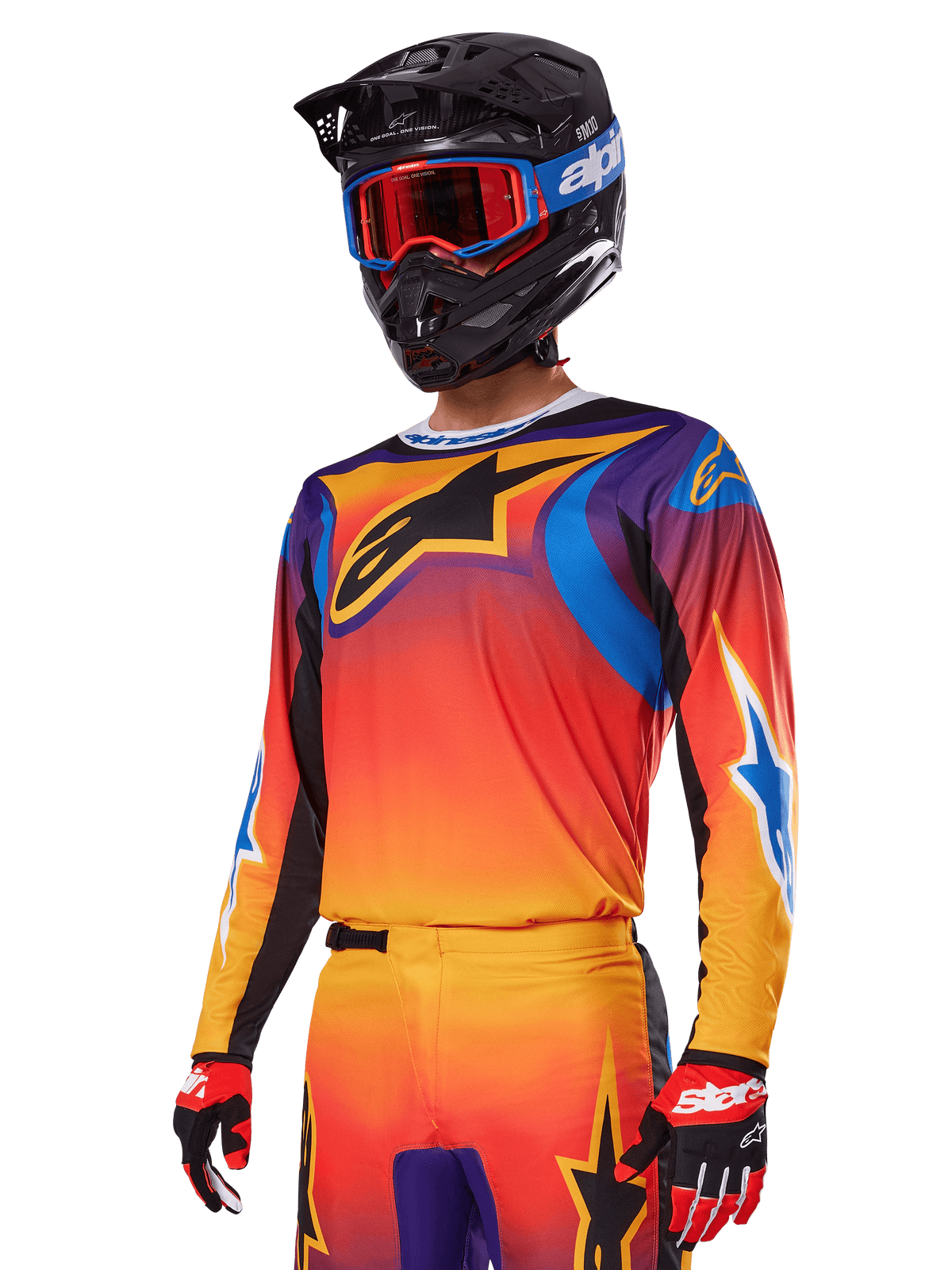 Alpinestars 2025 Fluid Wurx Gear Set, zestaw motocrossowy, gradient pomarańczowy, fioletowy i niebieski, z dużym czarnym logo A-stars, noszony z czarnym kaskiem i niebieskimi goglami, dopasowany strój do profesjonalnych wyścigów terenowych