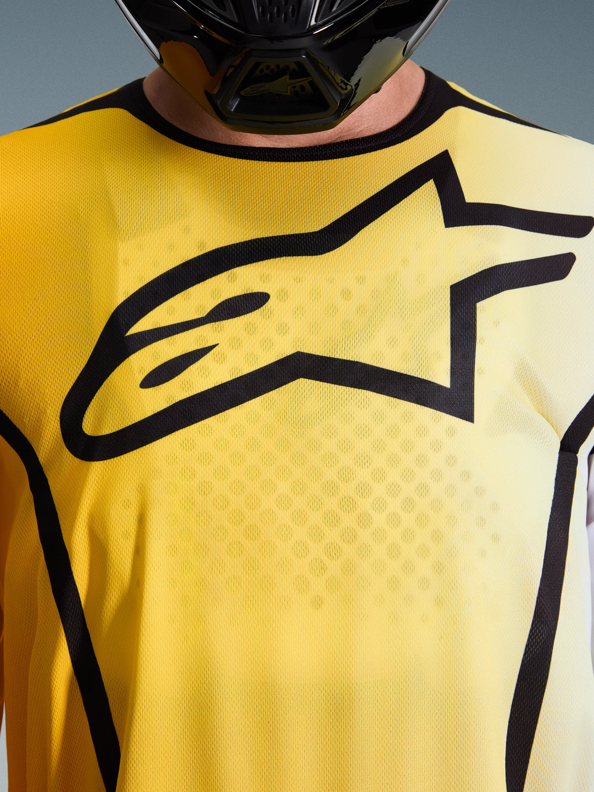 Alpinestars 2026 Fluid Apex Jersey, Motocross Jersey, Bright Yellow and Black, close-up view featuring a large black Astar logo on the chest, breathable moisture-wicking polyfabric with a sport collar.
