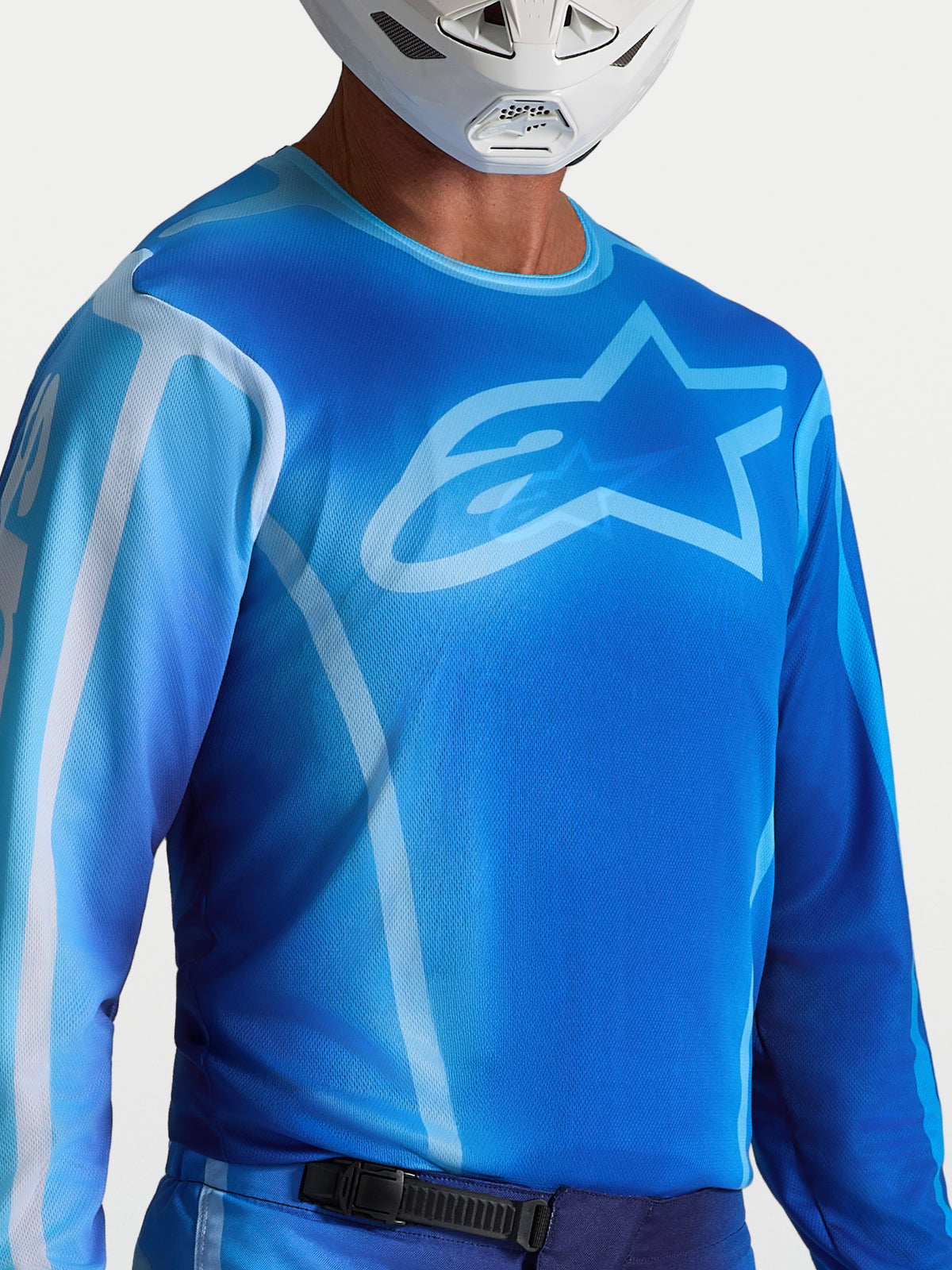 Alpinestars Fluid Kepler, niebieska koszulka motocrossowa, sportowy krój, materiał odprowadzający wilgoć, logo Astars.