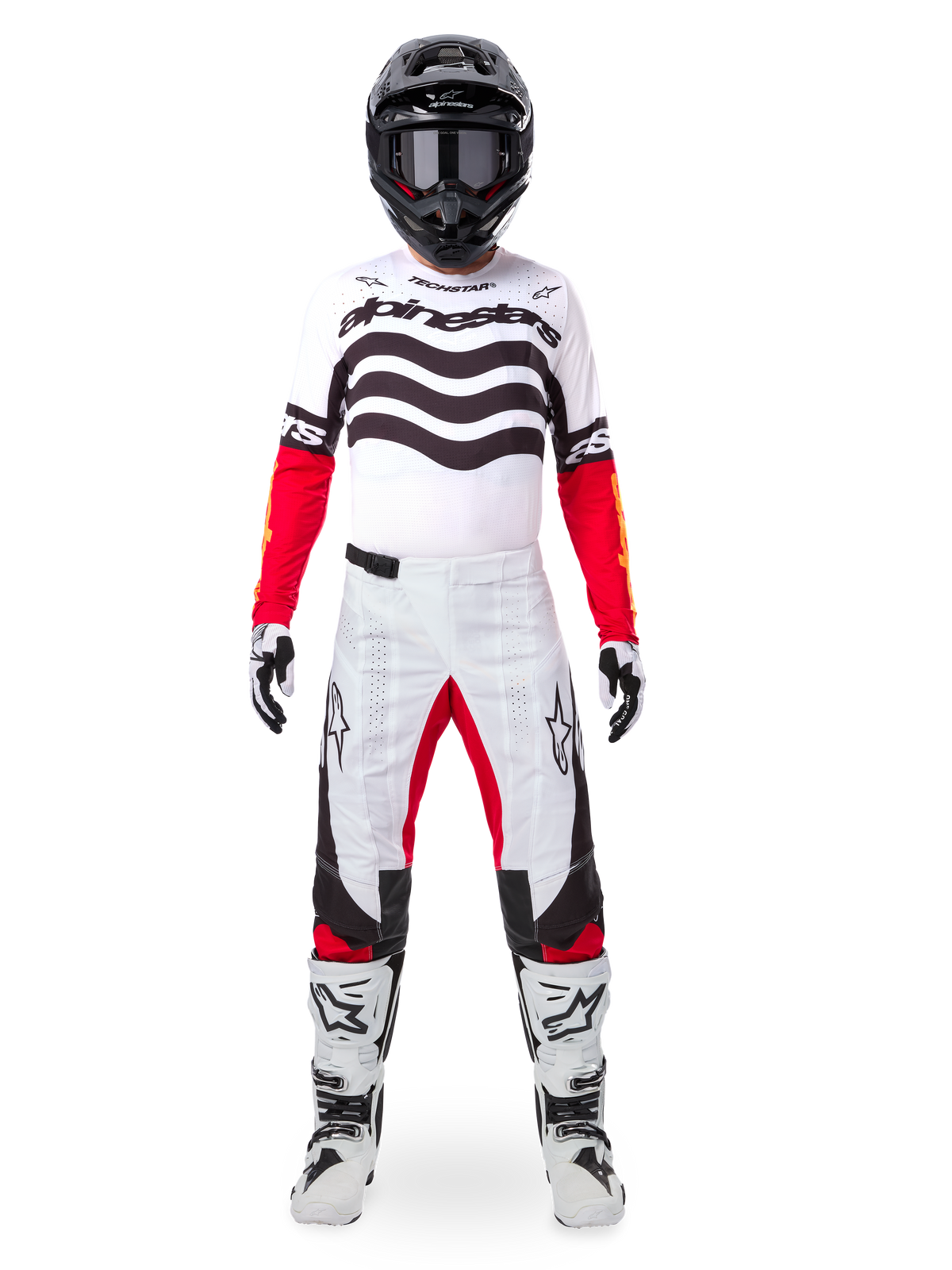 Motocross rider wearing the Alpinestars Limited Edition Techstar Deep Gear Set, white jersey with black wave graphics and red sleeves, matching white and black pants with red inner thigh accents, black helmet with dark goggles, and white boots, full professional off-road racing outfit