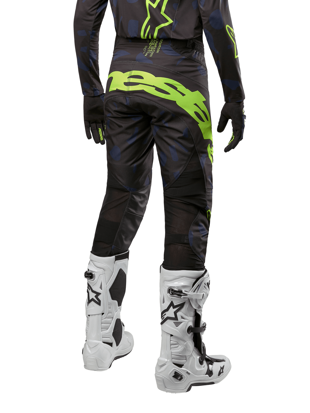 Alpinestars Techstar Rantera Pants 2024, spodnie motocrossowe, czarne, granatowe i neonowo-żółte, widok z tyłu, wyraziste neonowe logo i siatkowe panele wentylacyjne, noszone z pasującą bluzą i białymi butami, wytrzymały sprzęt do motocrossu i wyścigów off-road