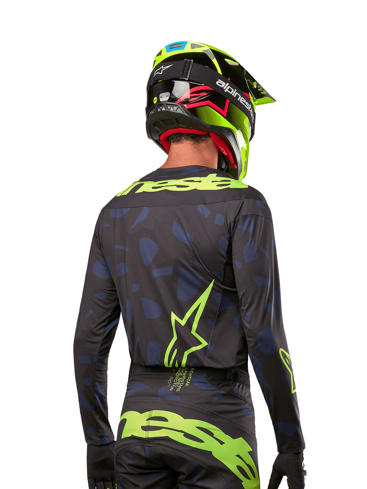 Widok z tyłu zawodnika motocrossowego w koszulce Alpinestars Techstar Rantera 2024 w kolorze Black Navy Yellow Fluo, z wyraźnym neonowo-żółtym brandingiem i logo na plecach, w zestawie z pasującymi spodniami motocrossowymi i neonowo-żółtym kaskiem, tworzącymi kompletny wyścigowy wygląd off-road.