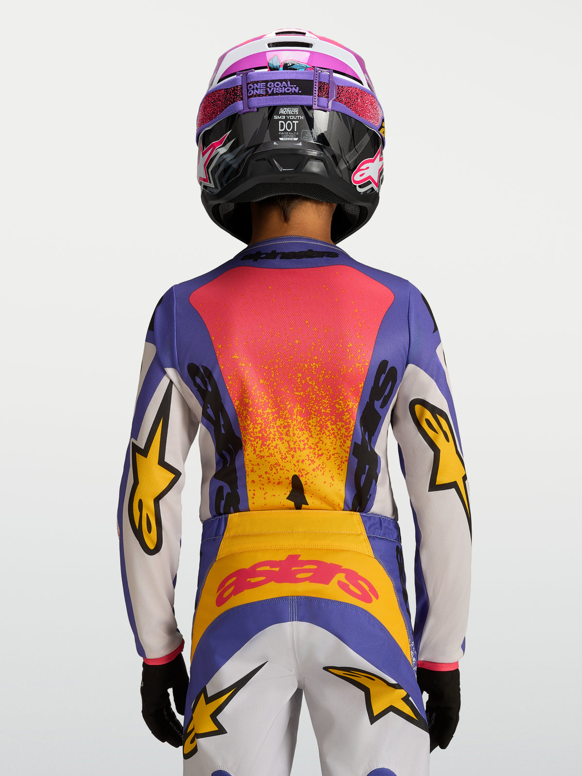 Alpinestars Koszulka Fluid Drag Młodzieżowe 2027, niebiesko-żółta koszulka motocrossowa, widok z tyłu, grafika wyścigowa.