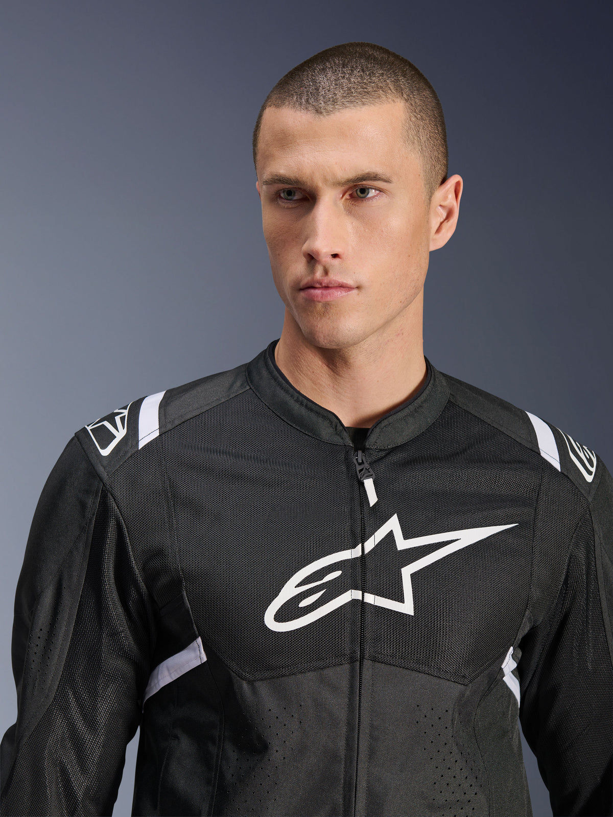 Alpinestars T-SPS Air V2 Jacket, Textile Motorcycle Jacket, Black and White, featuring large white chest logo and mesh paneling, performance sport fit worn by male model