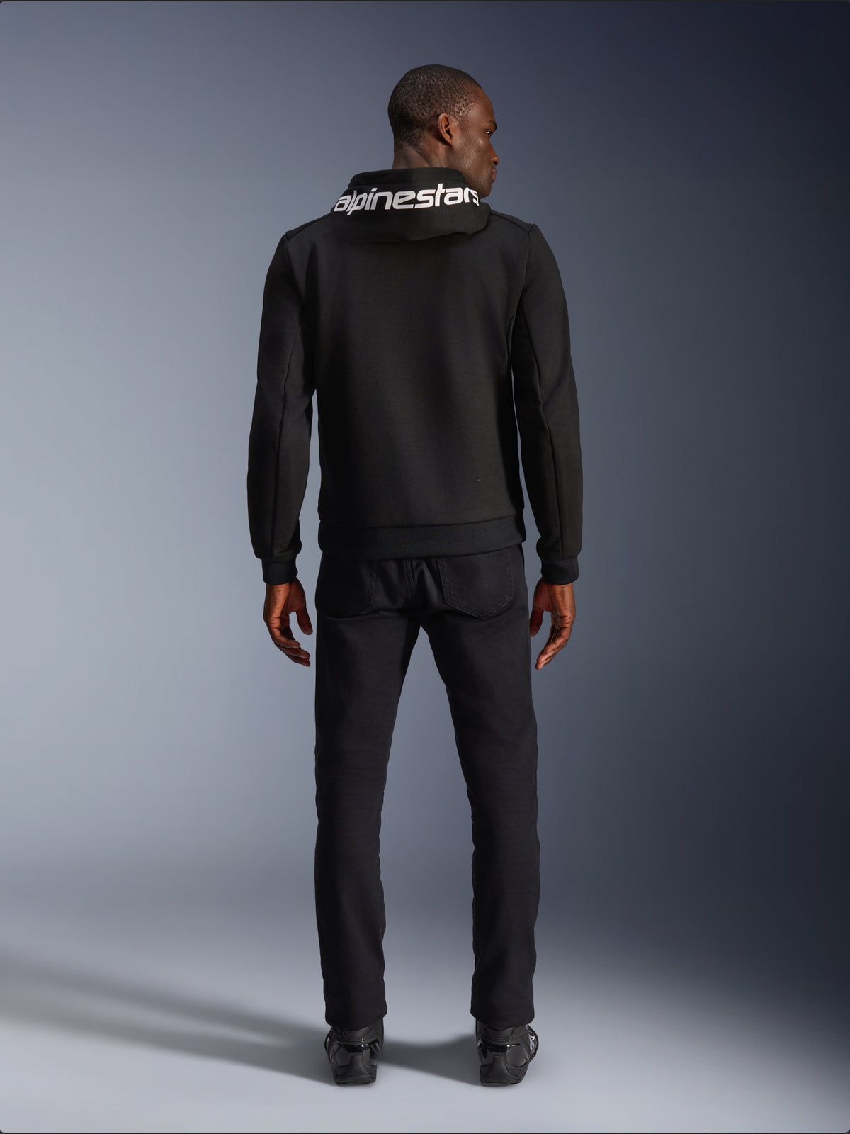 Alpinestars Chrome V2 Sport Hoodie, black tech fleece motorcycle hoodie with white hood logo, rear view on model.