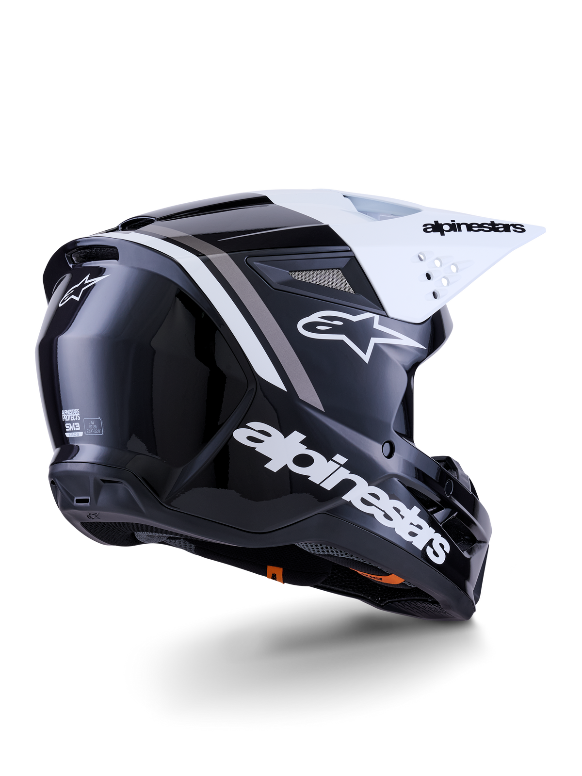 Kask Alpinestars S-M3 Radium, kask motocrossowy, czarno-biało-szary z połyskiem, widok z tyłu i z boku z białym daszkiem, z wyraźnym logo Alpinestars z boku i z tyłu, smukła aerodynamiczna skorupa z siatką wentylacyjną, zaprojektowany do jazdy off-road, motocross i enduro