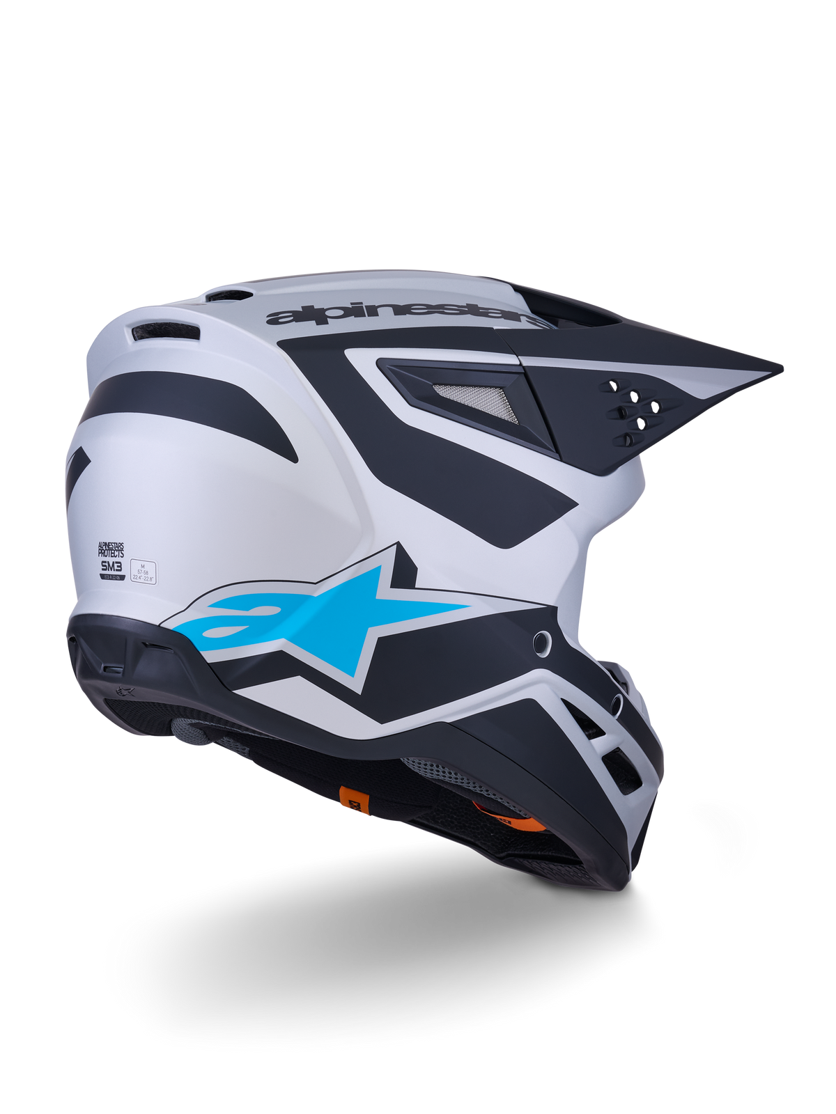 Alpinestars S-M3 Heat Helmet ECE 22.06, kask motocrossowy, srebrno-niebieski i czarny mat, widok z tyłu z dużym niebieskim logo gwiazdy i czarnymi kanciastymi wzorami, aerodynamiczna skorupa z otworami wentylacyjnymi, wysokowydajna ochrona do wyścigów off-road