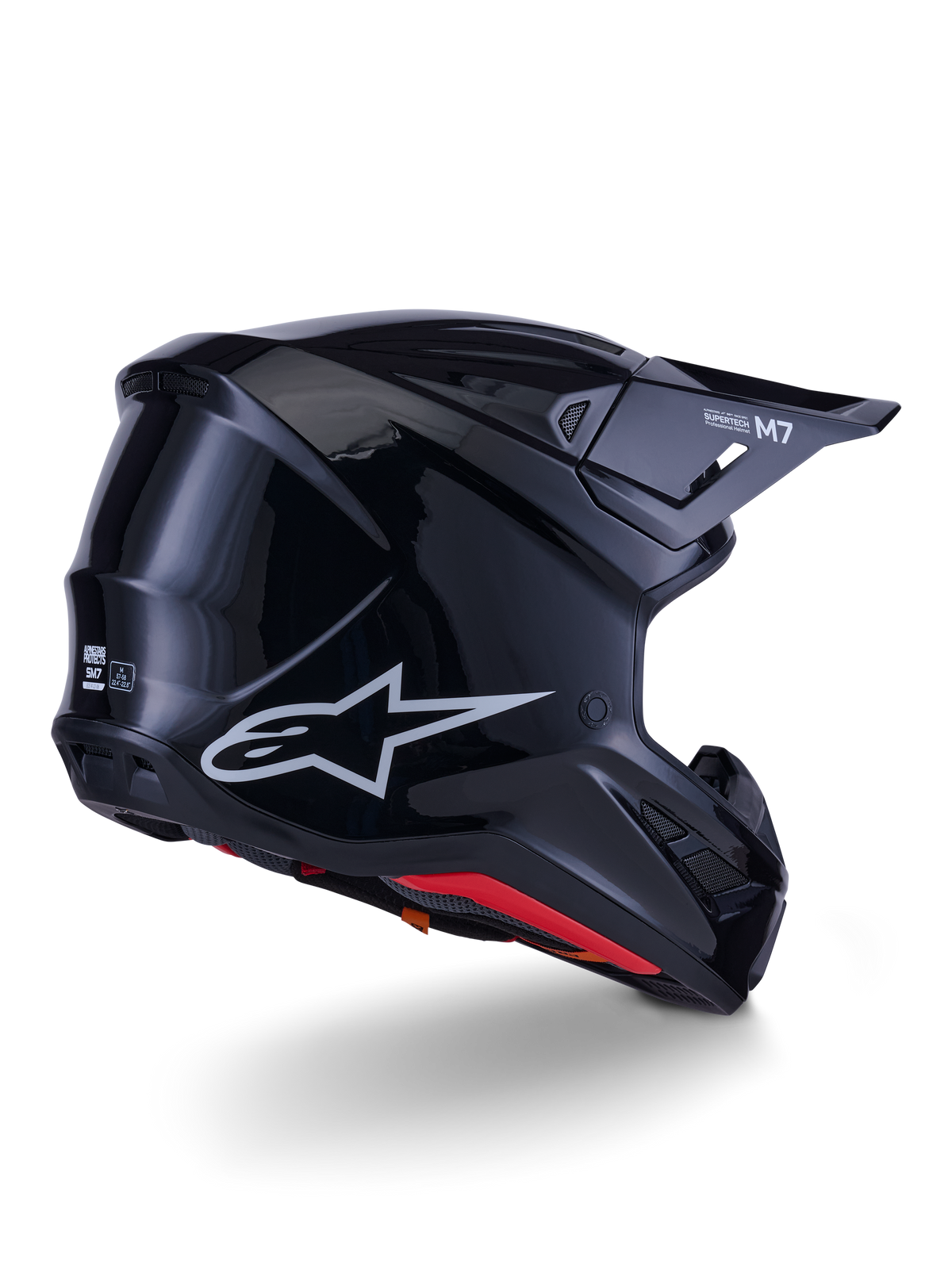 Alpinestars S-M7 Solid Helmet, kask motocrossowy, czarny połysk, z aerodynamiczną skorupą, srebrnym logo Astars, czerwonym wykończeniem wnętrza i zintegrowanymi otworami wentylacyjnymi, zaprojektowany dla ochrony w wyścigach off-road