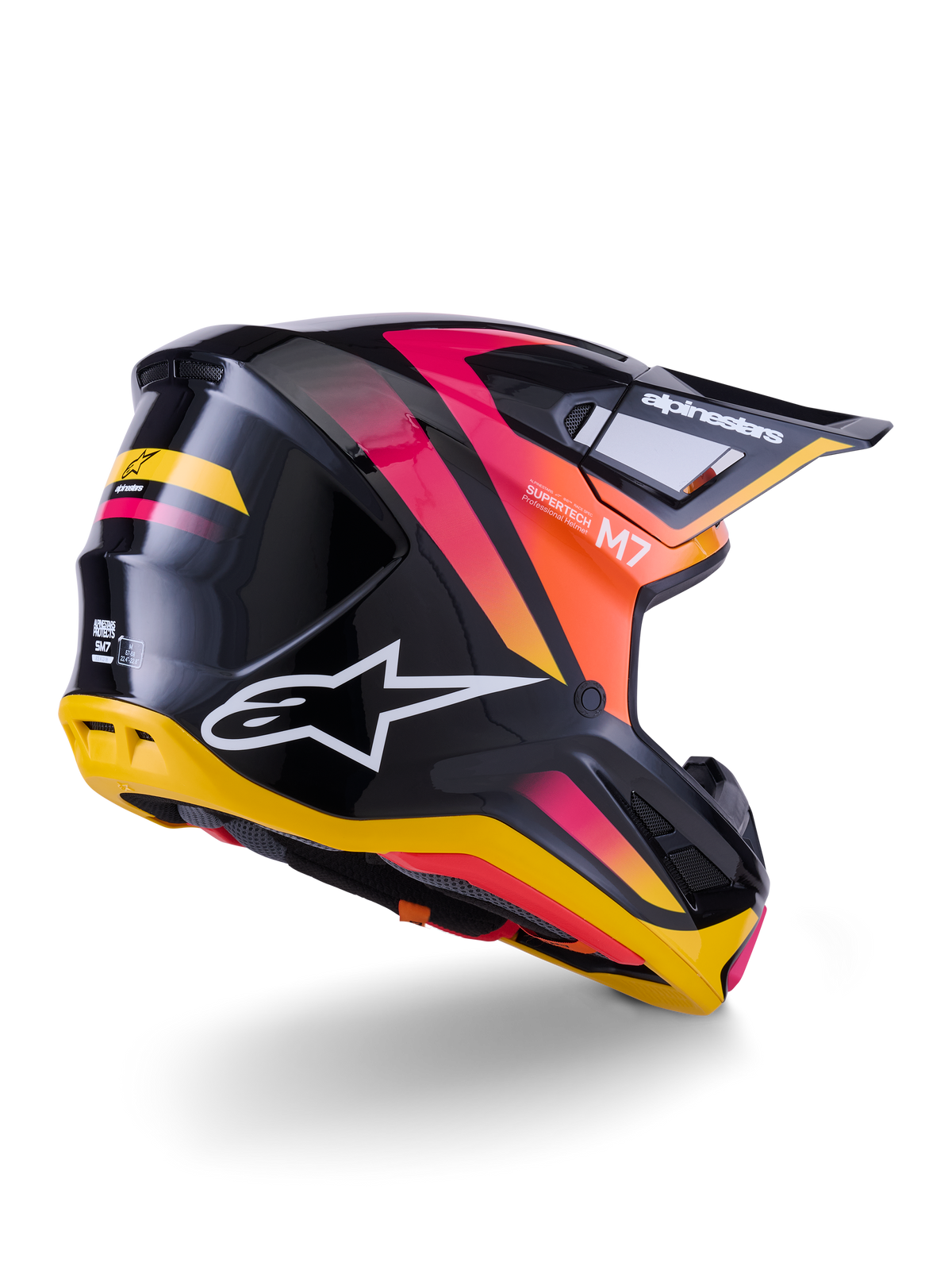Kask Alpinestars S-M7 Rise, kask motocrossowy, czarno-żółto-różowy z połyskiem, widok z tyłu i z boku prezentujący aerodynamiczną skorupę kompozytową z żywymi gradientami, wyraźnym brandingiem i otworami wentylacyjnymi
