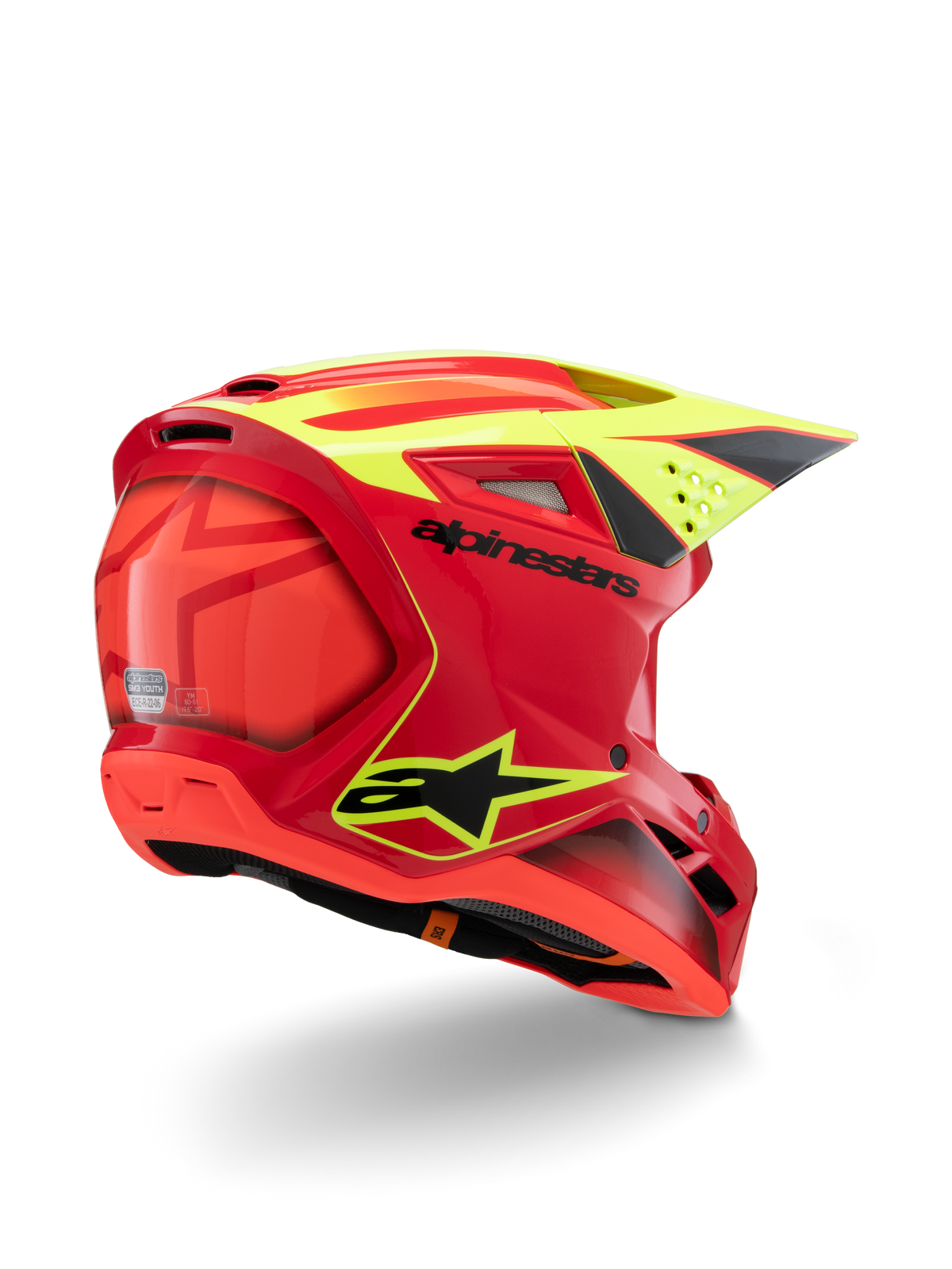 Kask Alpinestars S-M3 Youth Fray, czerwony i żółty fluo z połyskiem, widok z tyłu z boku, z wyraźnymi czarnymi logo i aerodynamicznymi otworami wentylacyjnymi, młodzieżowy kask motocrossowy o wysokiej widoczności