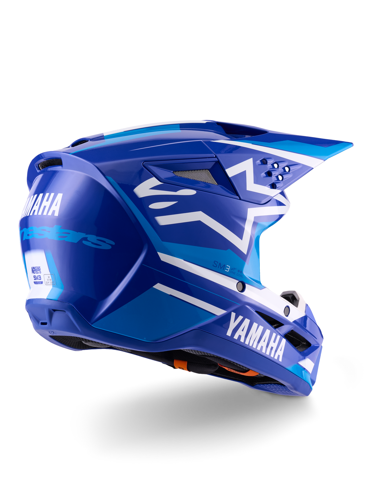 Kask Alpinestars Yamaha S-M3 ECE 22.06, kask motocrossowy, niebiesko-biały z połyskiem, z brandingiem Yamaha i Alpinestars, białe logo gwiazdy z boku, liczne otwory wlotowe i wylotowe, aerodynamiczna konstrukcja do jazdy w terenie