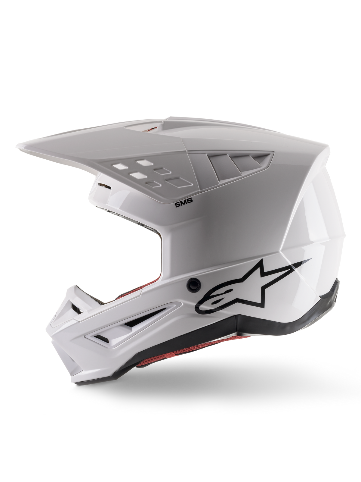 Alpinestars S-M5 Solid Helmet ECE 22.06, kask motocrossowy, biały połysk, widok z profilu bocznego z kanciastą konstrukcją skorupy, czarne logo Alpinestars z boku, liczne otwory wentylacyjne i zintegrowany daszek do wyścigów off-road.
