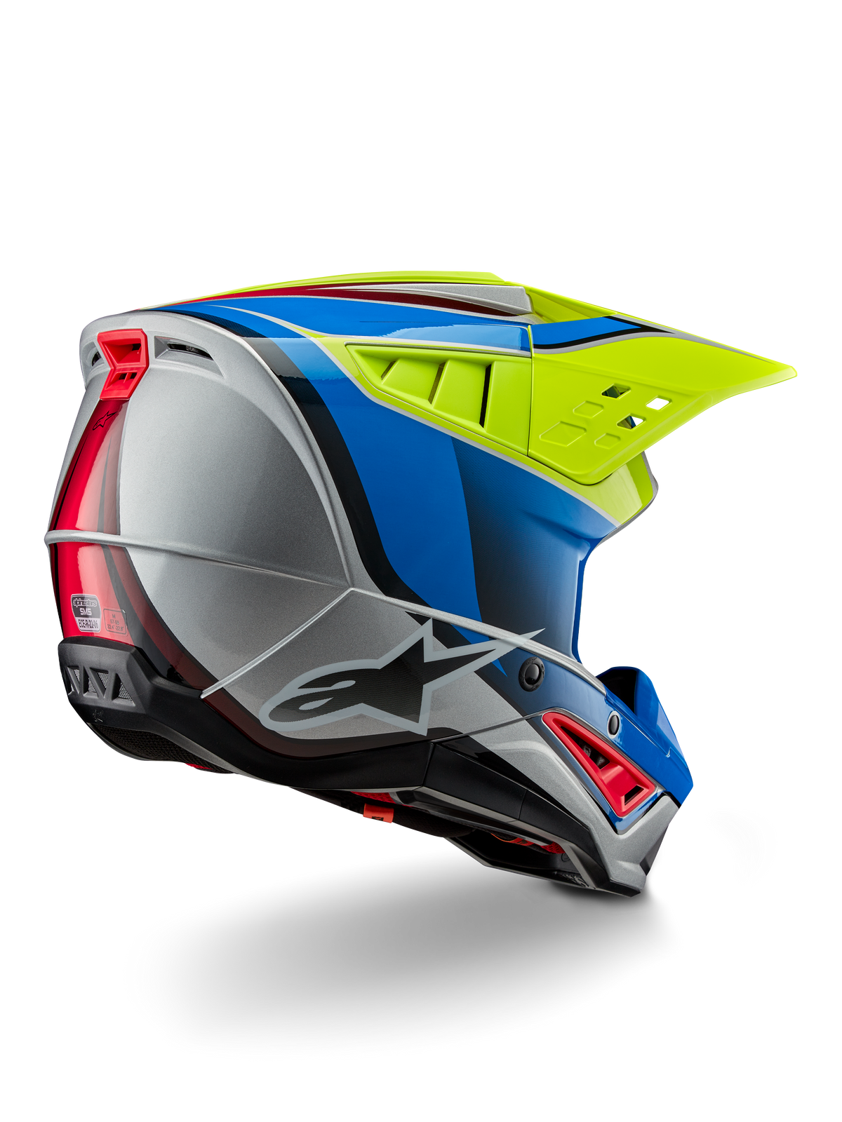 Kask Alpinestars S-M5 Sail ECE, kask motocrossowy, żółty fluo, emaliowany niebieski i srebrny połysk, widok z tyłu pod kątem trzech czwartych ukazujący aerodynamiczną skorupę termoplastyczną, duży wentylowany daszek oraz zintegrowane otwory wentylacyjne zapewniające ochronę podczas wyścigów off-road