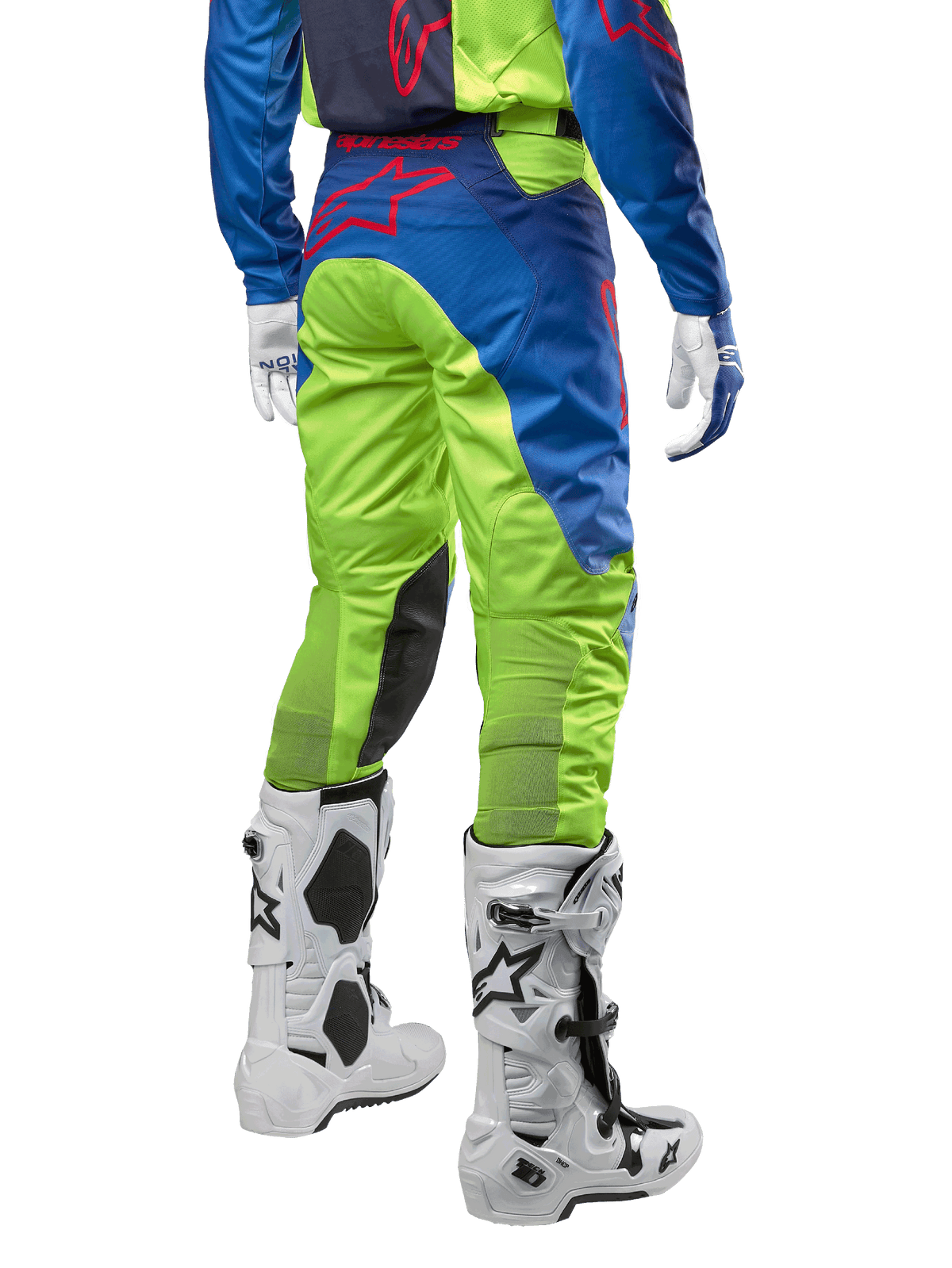 Alpinestars 2024 Racer Hoen Pants, Motocross Pants, Yellow Fluo and Blue Night Navy, back view, featuring a red Alpinestars logo, worn with matching jersey, white gloves, and white motocross boots, durable textile for off-road racing