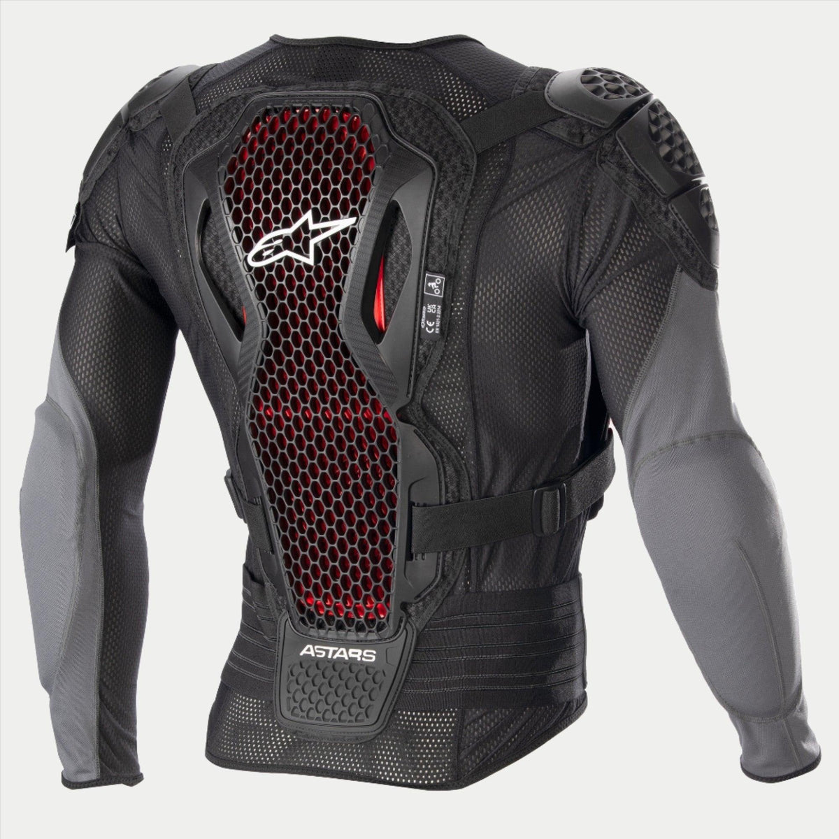 Alpinestars Bionic Plus V2 Protection Jacket, kurtka ochronna do motocrossu, czarna i antracytowa z czerwonymi detalami o strukturze plastra miodu, widok z tyłu pokazujący ochraniacz pleców z technologią Nucleon Cell Level 2, perforowana tkanina siatkowa oraz zintegrowane ochraniacze ramion i łokci.