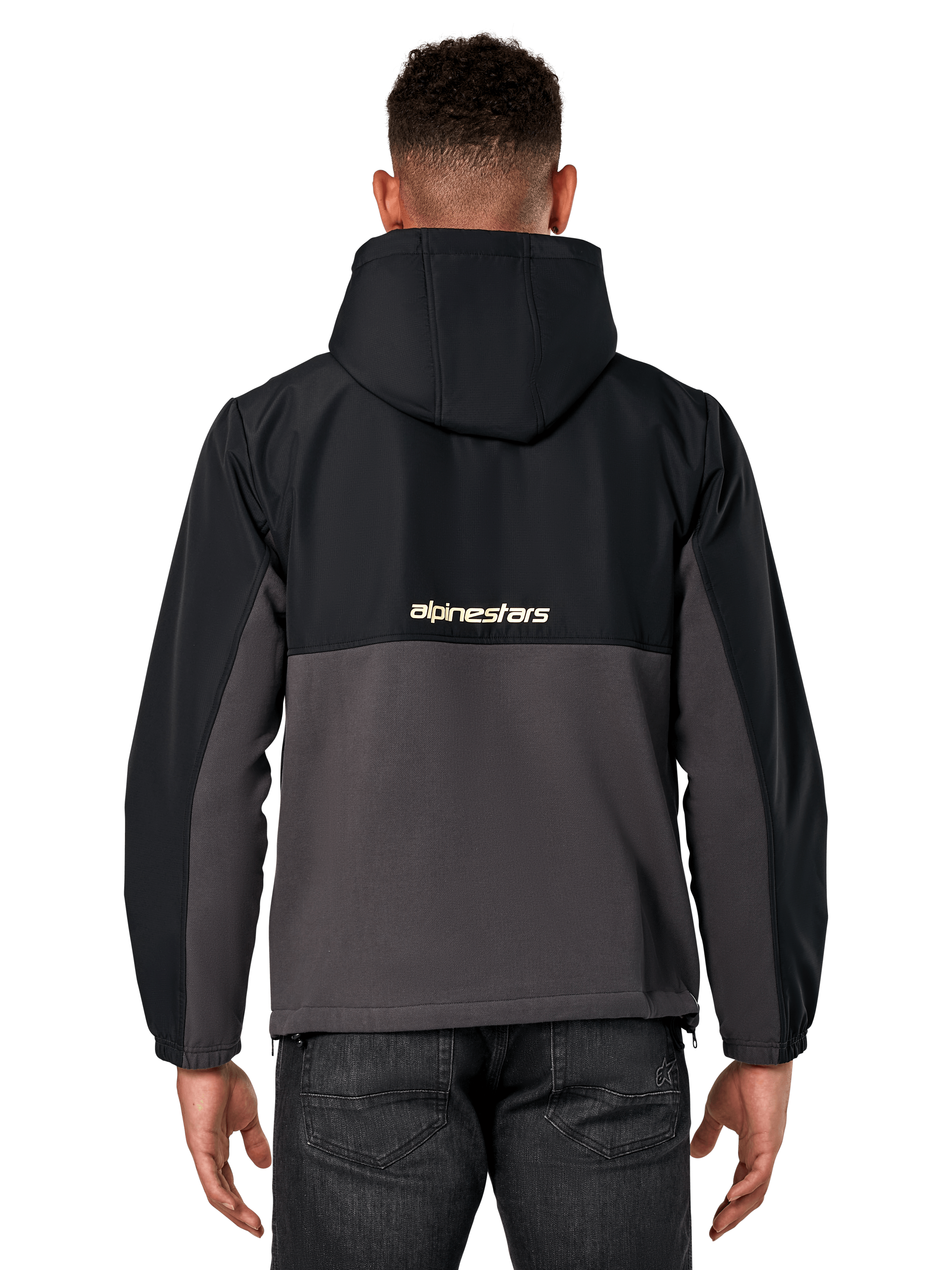 Kurtka Alpinestars Juncture Hybrid, widok z tyłu, czarny i gunmetal, casualowy anorak z mieszanych materiałów, góra z ripstopu i dół z polaru płóciennego, logo Alpinestars na plecach, noszona z ciemnymi spodniami