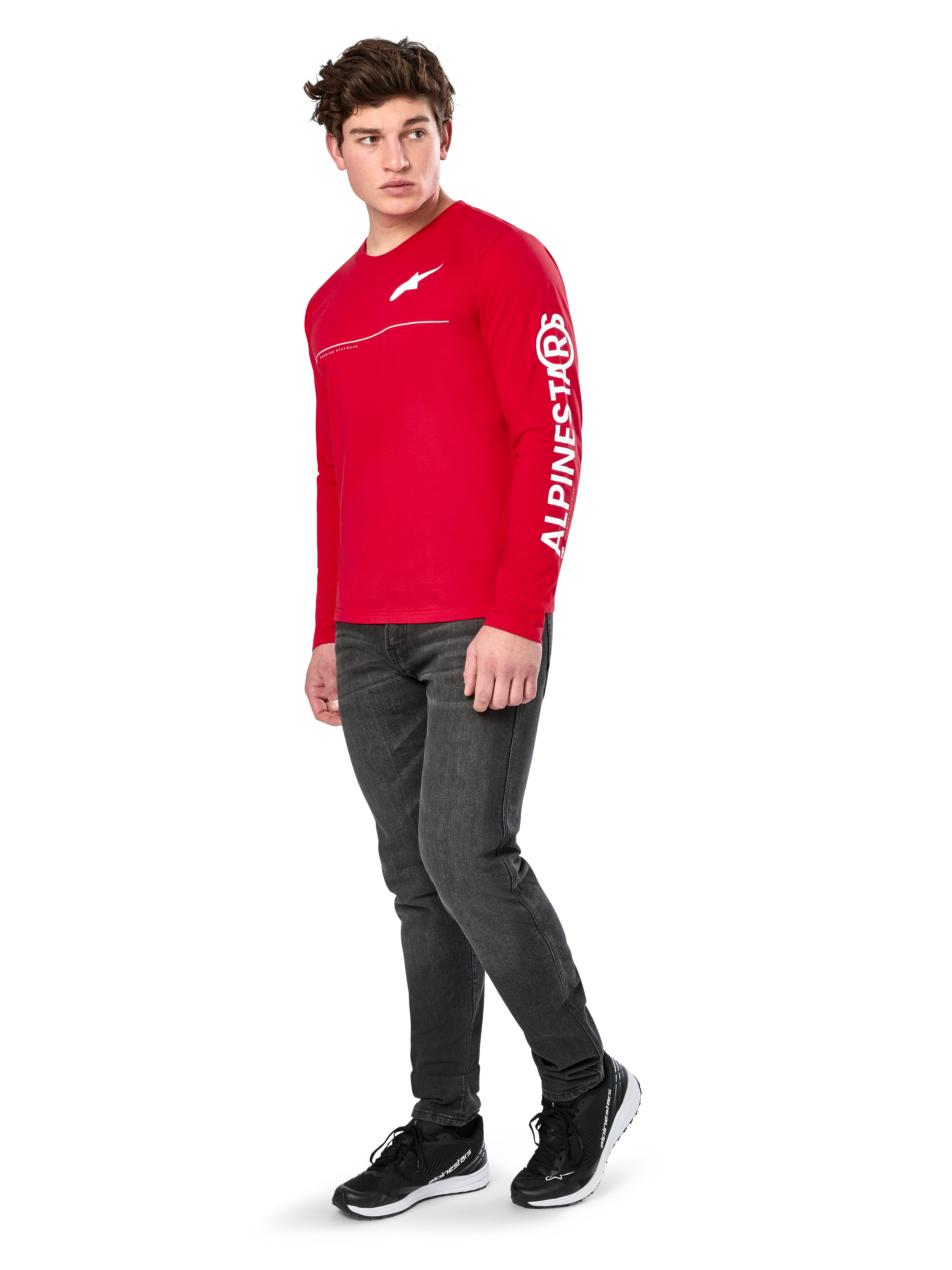 Alpinestars Committed CSF Tee, Long Sleeve T-Shirt, Red, featuring white Astars chest logo and Alpinestars sleeve branding, worn by a model with dark jeans and black sneakers, casual motorsport streetwear