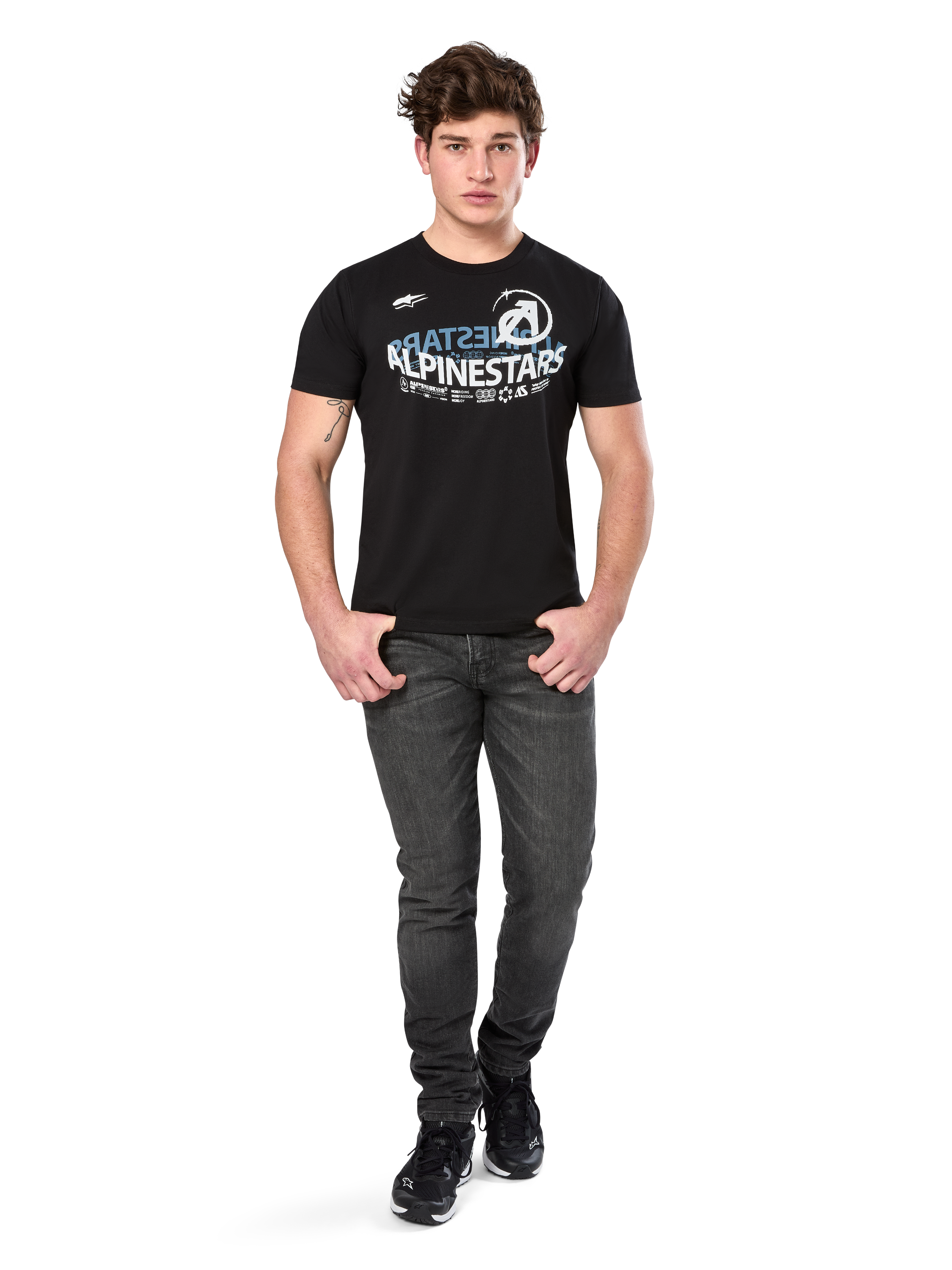 Alpinestars Semicircle CSF Tee, Short Sleeve T-Shirt, Black, White and light blue curved graphic on chest, worn by model with dark grey jeans and black sneakers, casual motorsport streetwear