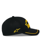 Alpinestars Luminary Hat, czarna czapka z daszkiem typu snapback, widok z boku, zakrzywiony daszek z żółtą lamówką sutache, żółte haftowane logo 3D i boczna gwiazda, 100% bawełna, codzienne nakrycie głowy inspirowane motorsportem