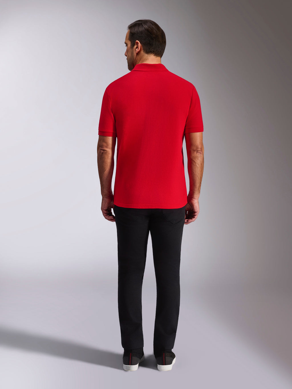 Alpinestars Endeavor Classic Polo, Red Pique Polo Shirt, back view, worn with black pants, casual motorsport streetwear featuring ribbed collar and sleeve cuffs