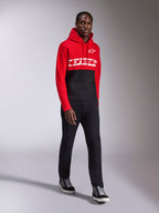 Alpinestars Parallel Hoodie, casual sportswear, Red and Black color-blocked design, featuring a white Alpinestars wordmark and star logo on the chest, worn with black pants and sneakers, modern motorsport-inspired look