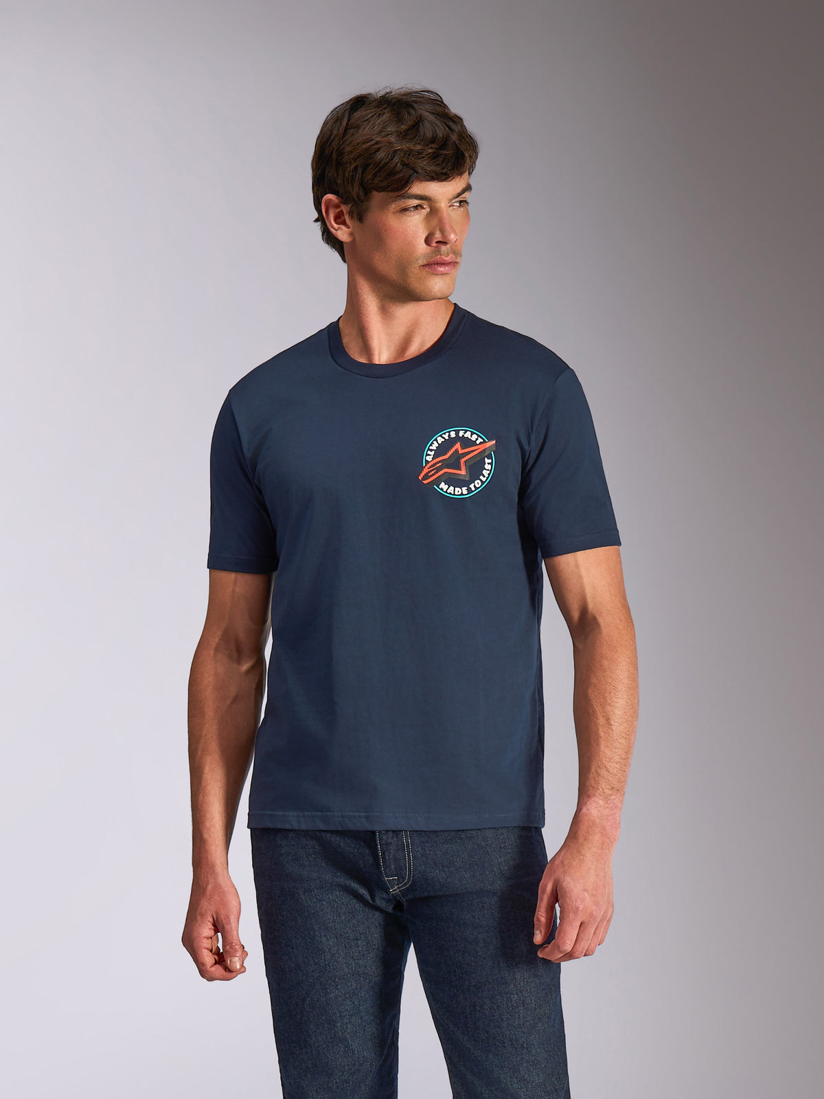 Alpinestars Aorbit CSF Tee, Short Sleeve T-Shirt, Navy Blue, circular chest graphic with orange Astars logo and 'Always Fast Made to Last' text, casual motorsport streetwear