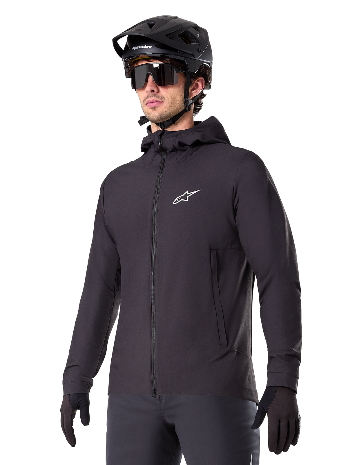 Alpinestars A-Dura Thermal Jacket, Black Cycling Jacket, hooded design with front zipper, white star logo on chest, worn with black mountain bike helmet and gloves, sporty performance gear for cold weather trail riding