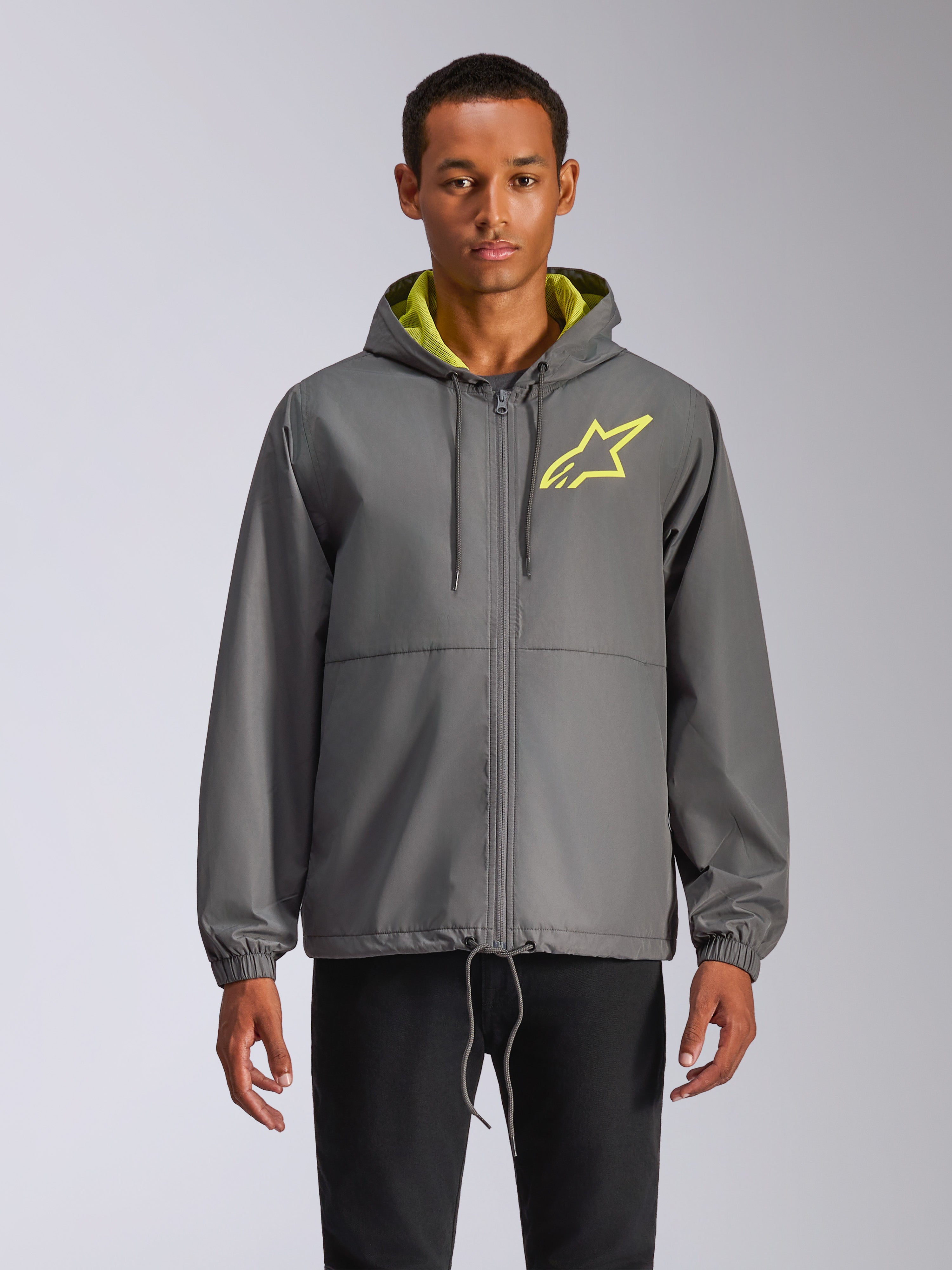 Alpinestars Speeder Chromium Windbreak Jacket, charcoal gray hooded windbreaker with hi-vis yellow star logo, lime green hood interior, elastic cuffs, adjustable drawstrings, front zipper closure, casual motorsport style
