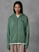 Alpinestars Essentials Ageless Zip Hoodie, Cactus Green, codzienna odzież streetwearowa noszona przez modelkę, rozpinana bluza z kapturem z małym czarnym logo na piersi, przednie kieszenie, luźny krój do noszenia na co dzień