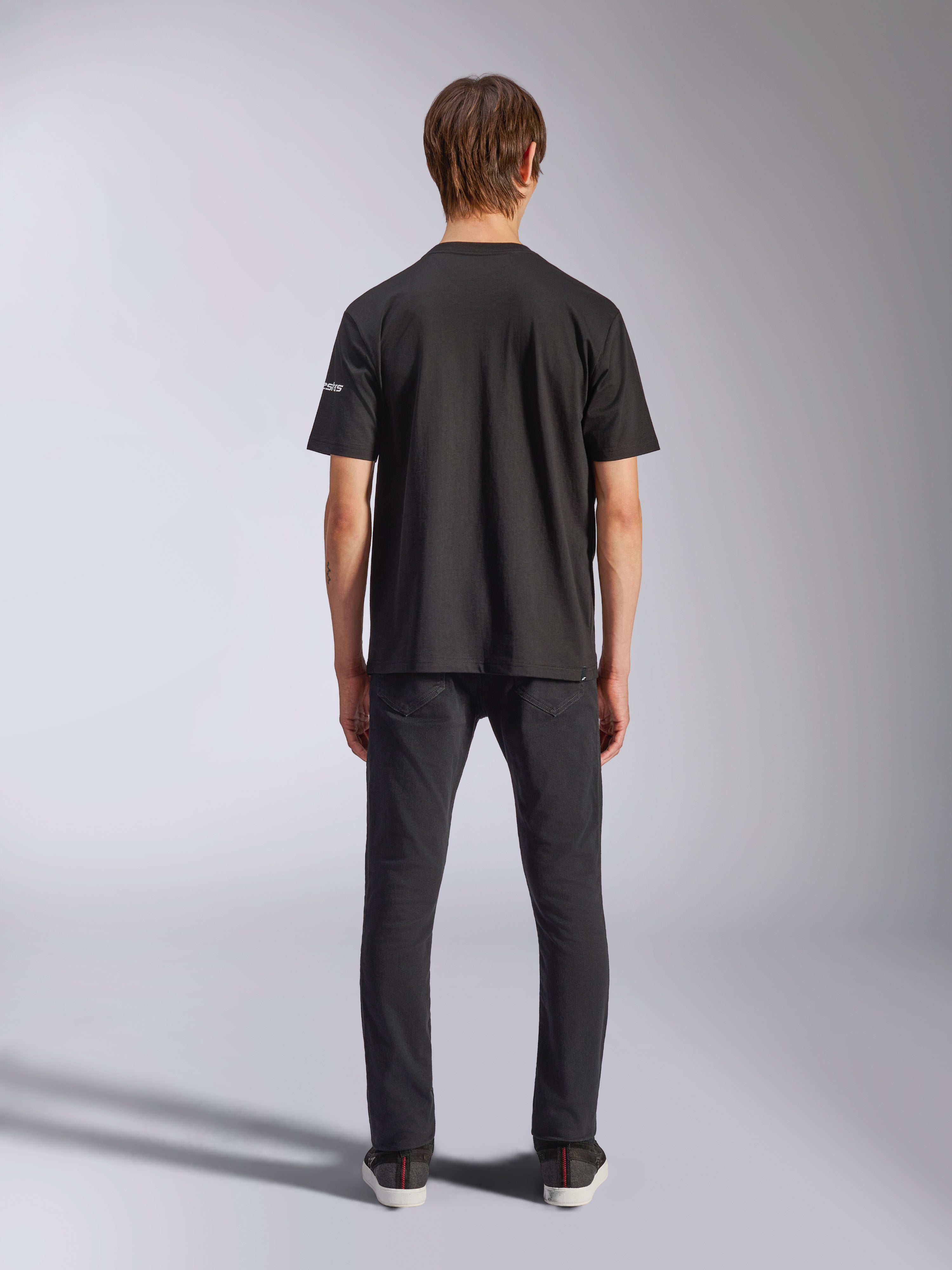 Alpinestars Frontal CSF Tee, Short Sleeve T-Shirt, Black, Rear view on model wearing black jeans, casual performance streetwear featuring small white sleeve logo detail