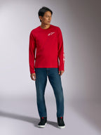 Alpinestars Trackside CSF Tee, Long Sleeve T-Shirt, Red with White Alpinestars Logo, lifestyle shot worn with blue jeans and black sneakers, casual motorsport-inspired sportswear