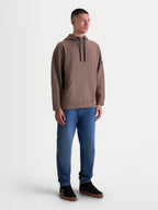 Alpinestars bluza z kapturem Camino Textured Oversize, męska brązowa bluza sportowa lifestyle, teksturowany polar o splocie twill, wysoki kołnierz i kieszeń typu kangurka, luźny fason oversize, pokazana na modelu.
