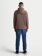 Alpinestars bluza z kapturem Camino Textured Oversize, męska bluza sportowa typu pullover, brązowa taupe, teksturowany polar dzianinowy o splocie twill, ściągacze przy mankietach i u dołu, widok z tyłu na modelu, luźny krój oversize.
