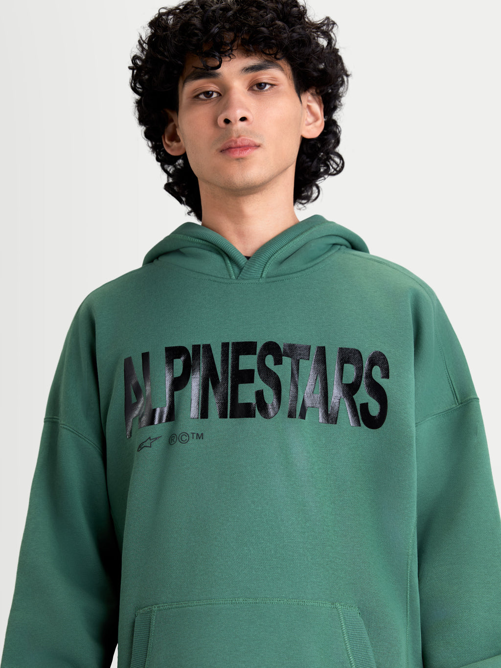 Alpinestars Shaw Oversized Hoodie, Green Sportswear Pullover for Men and Women, featuring a bold textured black Alpinestars word logo, relaxed oversized fit, and soft fleece construction.