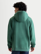 Alpinestars Shaw Oversized Hoodie, Green Sportswear Pullover, Unisex Relaxed Fit, Back View on Model, Self-Lined Hood and Ribbed Trims, Soft Cotton and Recycled Polyester Fleece Construction