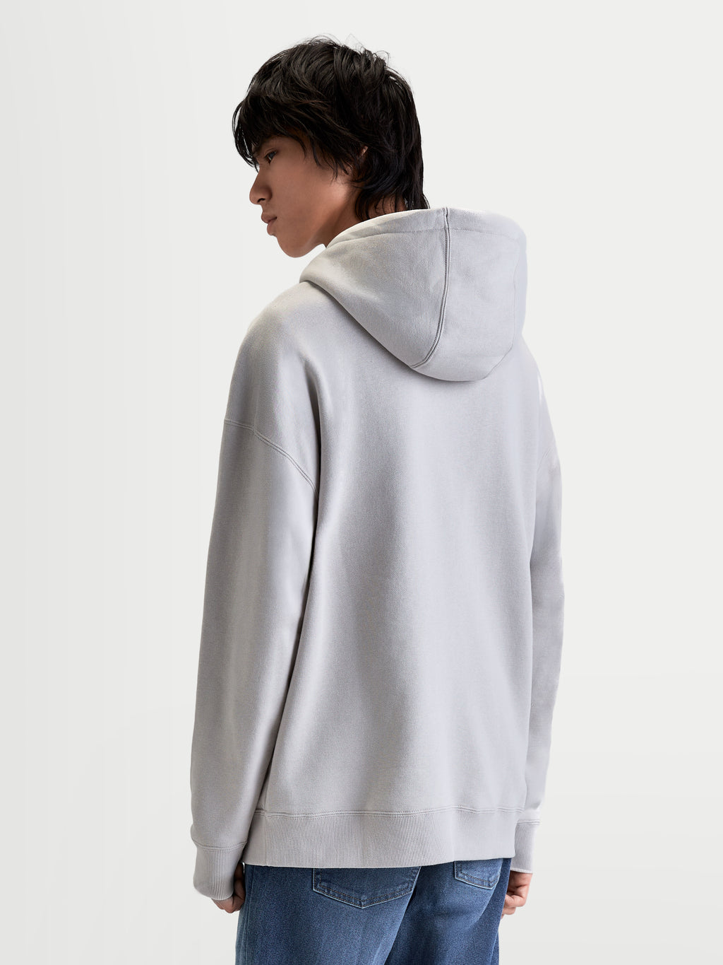Alpinestars Bluza Z Kapturem Prelude Oversize, sportowa szara bluza polarna, luźny krój oversize, kaptur z podszewką i szwy na rękawach, widok z tyłu na modelu.