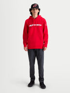 Alpinestars Bluza Z Kapturem Race Wordmark, czerwona bluza dresowa typu pullover, białe logo z napisem Alpinestars, kieszeń typu kangurka i regulowany kaptur, noszona przez modela, styl casual inspirowany motorsportem.