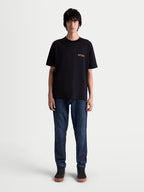 Alpinestars Latitude Oversized CSF Tee, Short Sleeve Sportswear T-shirt, Black and Orange, relaxed oversized fit, premium cotton-poly blend, featuring ASTARS chest graphic on model.