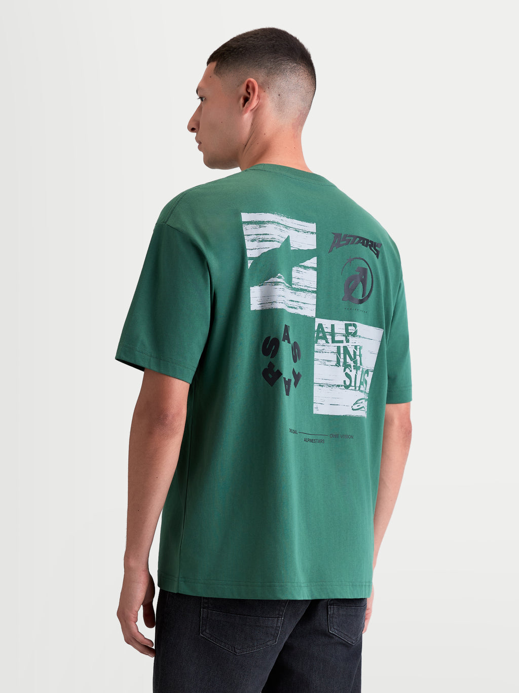 Alpinestars Checkback Oversized CSF Tee, Green Sportswear T-Shirt for Men and Women, Back View on Model featuring a bold White and Black Checker Graphic with Astars Logo and Motorsport Branding, Casual Oversized Fit.
