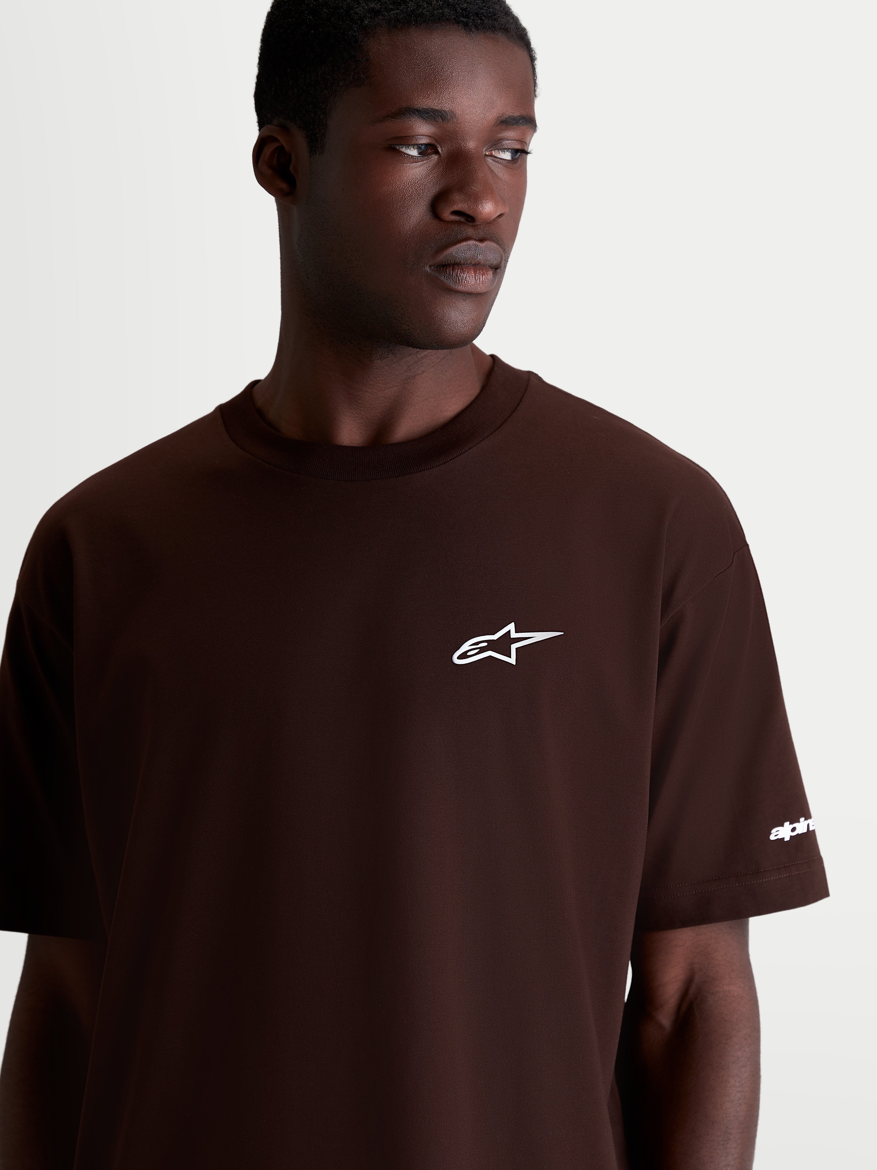 Alpinestars Mandate Oversized CSF Tee, Short Sleeve Casual Sportswear, Brown with White Astars Logo, Men's and Women's Relaxed Oversized Fit, Cotton-Poly Blend, On-Model Detail Shot.