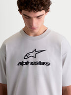 Alpinestars Prelude Oversized CSF Tee, Men's Sportswear Short Sleeve T-Shirt in Cement Gray, featuring a black soft hand-print Astars stacked logo on the chest, relaxed oversized fit, and comfortable cotton-poly blend construction for everyday casual wear.