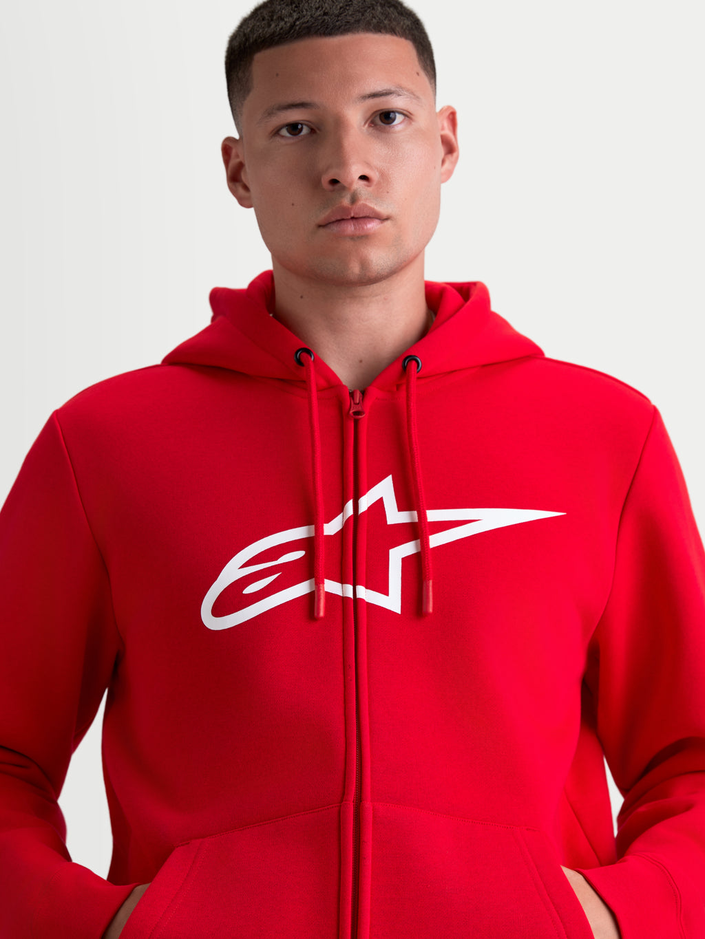 Alpinestars bluza z kapturem Ageless Zip V3, sportowa bluza polarowa zapinana na zamek, czerwona i biała, duże białe logo A-star na piersi, regulowany kaptur ze sznurkami, ukryty zamek, styl motorsportowy.