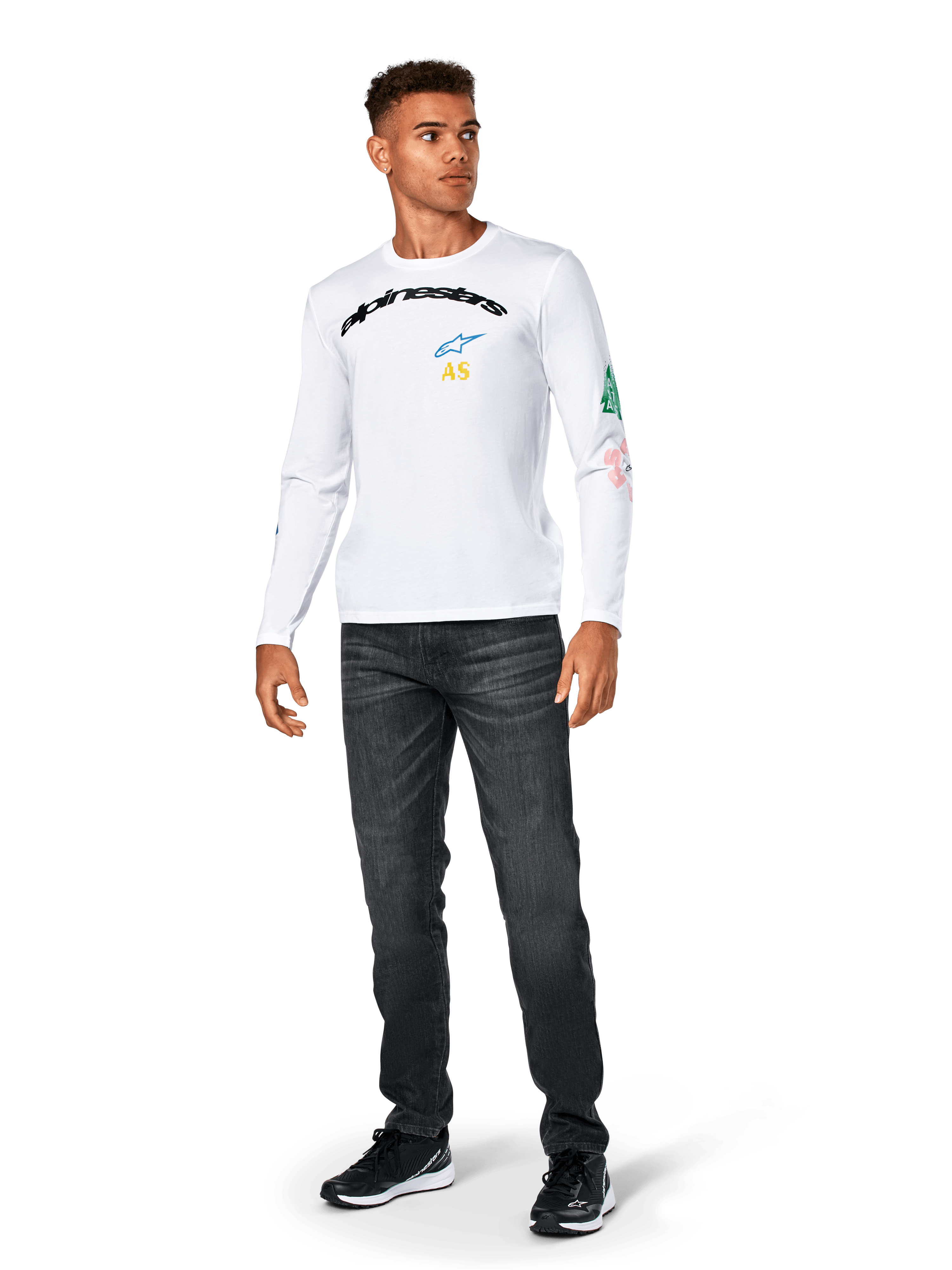 Alpinestars Brundo CSF Tee - Long Sleeve, biała, codzienna odzież sportowa, czarny napis „alpinestars” na piersi, niebieskie logo z gwiazdą i żółte inicjały „AS”, kolorowe grafiki na rękawie, noszona z ciemnymi dżinsami i czarnymi sneakersami
