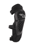 Alpinestars Bionic Plus, ochraniacze na kolana i golenie, czarne, ochrona off-road i MTB, perforowana skorupa o strukturze plastra miodu z białym logo Alpinestars, podwójne regulowane paski, wentylacja z siatki 3D, ergonomiczny zakrzywiony kształt