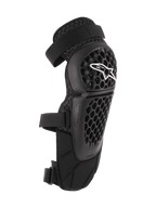 Alpinestars Bionic Plus, ochraniacze na kolana i golenie, czarne, ochrona off-road i MTB, perforowana skorupa o strukturze plastra miodu z białym logo Alpinestars, podwójne regulowane paski, wentylacja z siatki 3D, ergonomiczny zakrzywiony kształt