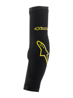 Alpinestars Paragon Plus Elbow Protectors, Black and Acid Yellow, slip-on sleeve design with integrated padding, featuring yellow star logo and script branding, breathable mesh for MTB protection