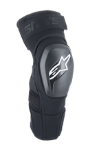Alpinestars A-Impact Plasma Elite Shield, ochraniacze na kolana, czarne z białym logo gwiazdy, twarda zewnętrzna skorupa TPU, tkanina siatkowa z regulowanym górnym paskiem, wstępnie zakrzywiony ergonomiczny kształt, ochrona do MTB i off-road